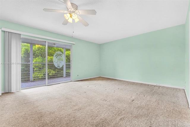 carpeted empty room with baseboards and ceiling fan