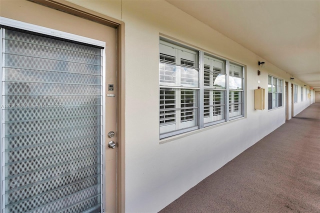 entrance to property featuring stucco siding