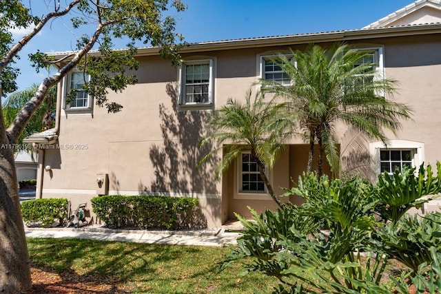view of side of property with stucco siding