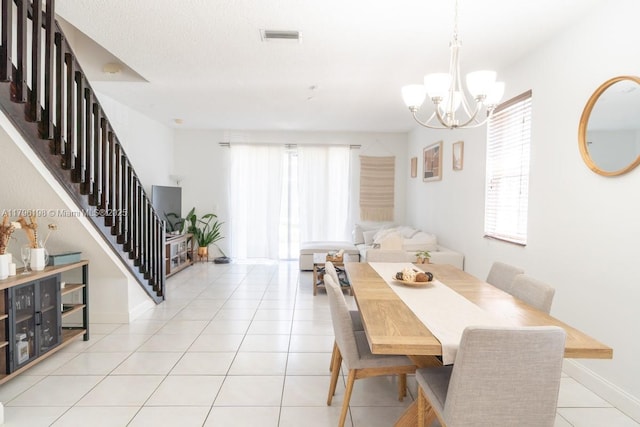 dining area with a wealth of natural light, stairs, and visible vents