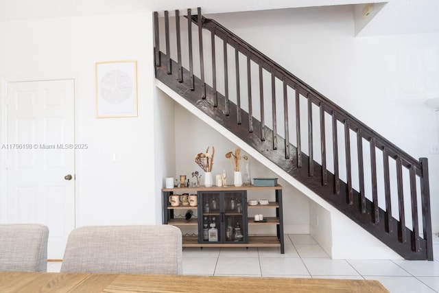 stairway with tile patterned flooring
