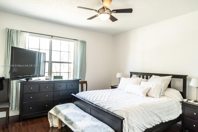 bedroom featuring a ceiling fan and dark wood finished floors