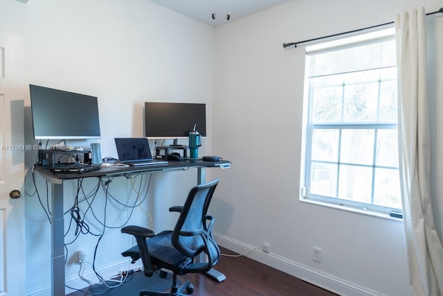 office area with baseboards, wood finished floors, and a wealth of natural light
