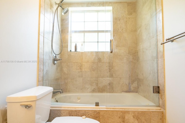 full bath featuring tiled shower / bath combo and toilet