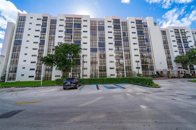 view of property featuring uncovered parking