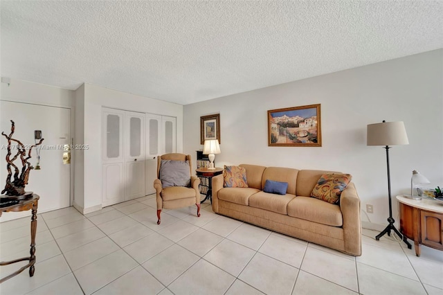 living area featuring light tile patterned floors and a textured ceiling
