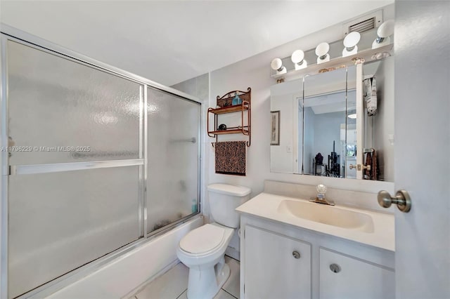bathroom featuring visible vents, tile patterned flooring, vanity, toilet, and shower / bath combination with glass door