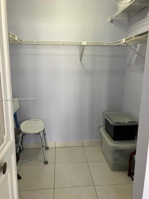 walk in closet with tile patterned flooring
