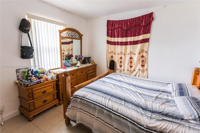 bedroom with multiple windows and light tile patterned floors