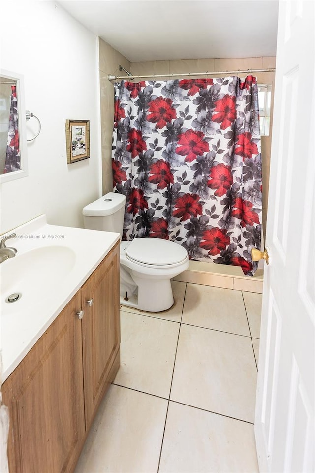 bathroom with vanity, toilet, tile patterned floors, and curtained shower