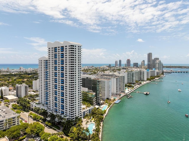 birds eye view of property with a view of city and a water view