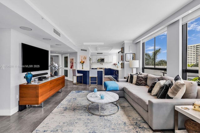 1330 W Ave Unit 407, Miami Beach, FL 33139 - living area with finished concrete flooring, baseboards, visible vents, and recessed lighting