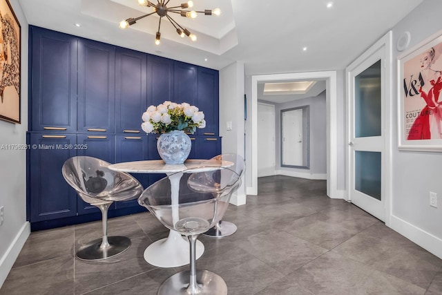 dining area featuring baseboards and a chandelier