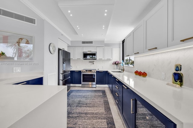 kitchen with visible vents, blue cabinets, and stainless steel appliances