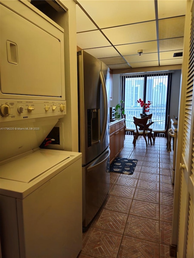 washroom with laundry area and stacked washing maching and dryer