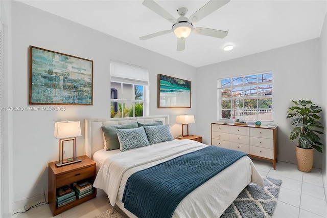 bedroom with ceiling fan and light tile patterned floors