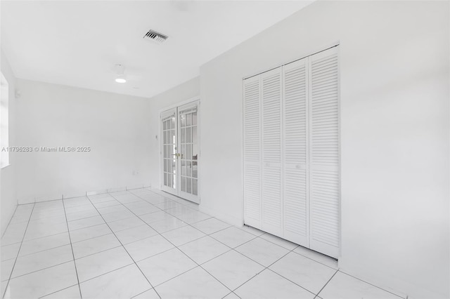 spare room with visible vents and light tile patterned floors
