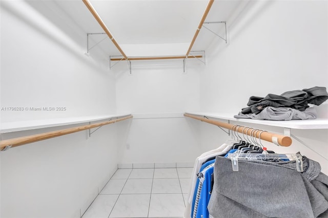 spacious closet featuring light tile patterned floors