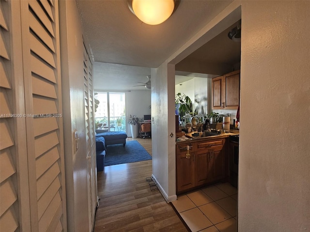 1035 W Ave Unit 406, Miami Beach, FL 33139 - hallway featuring a sink and light wood-type flooring