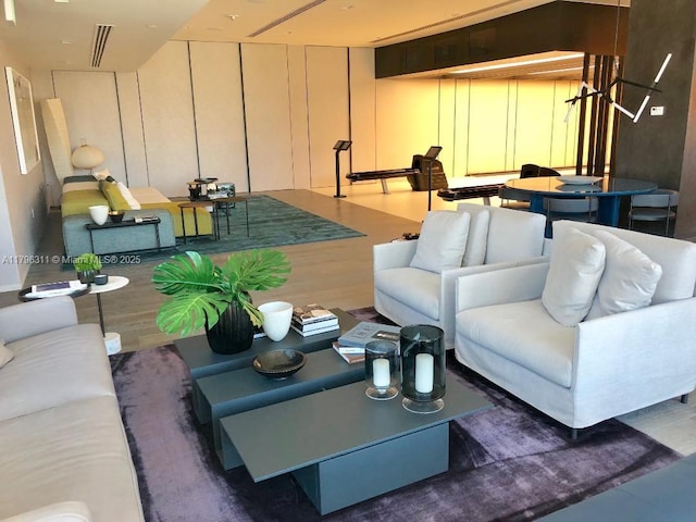 living room with visible vents and wood finished floors