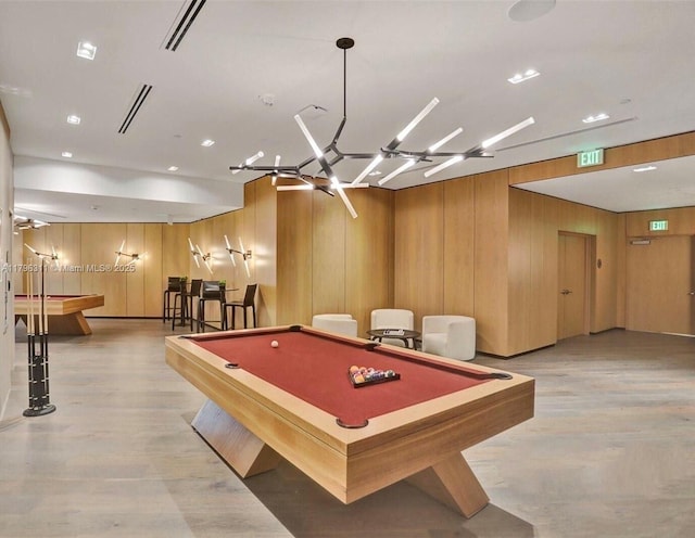 playroom with wooden walls, billiards, an inviting chandelier, and light wood-type flooring