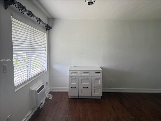 3800 NE 21st Ave Unit 12, Lighthouse Point, FL 33064 - interior space with baseboards, a wall mounted air conditioner, and dark wood-style flooring
