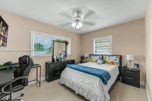 bedroom with baseboards, multiple windows, and ceiling fan