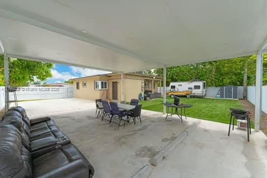 view of patio featuring outdoor dining area and fence