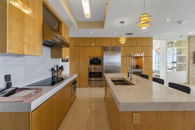 kitchen with brown cabinetry, modern cabinets, a sink, black electric stovetop, and stainless steel built in refrigerator