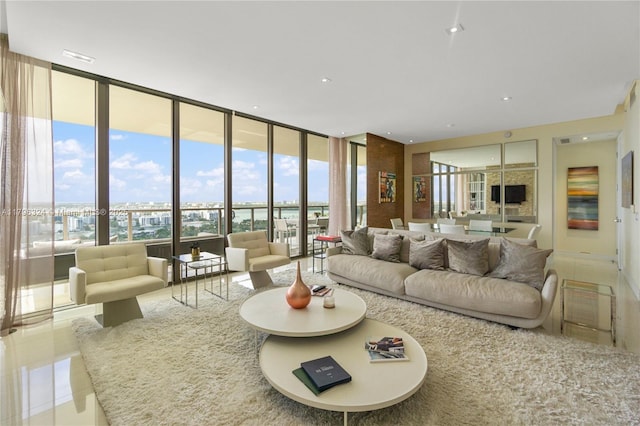 living area with floor to ceiling windows, a wealth of natural light, and tile patterned flooring