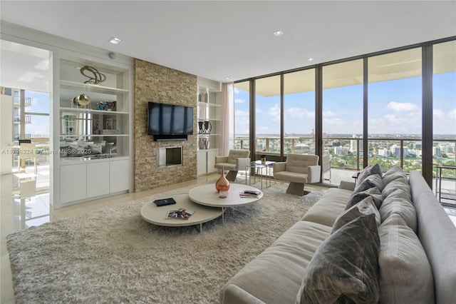living room featuring a wall of windows, plenty of natural light, and built in shelves