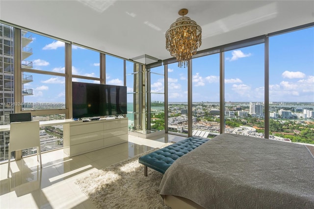 bedroom with a wall of windows, tile patterned floors, and an inviting chandelier