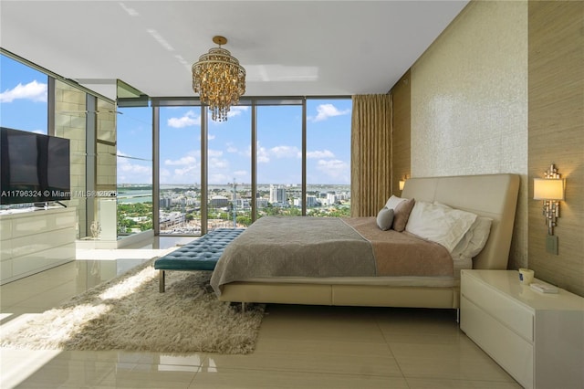 tiled bedroom featuring a notable chandelier, a wall of windows, and a city view