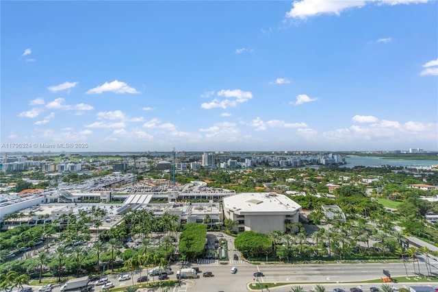 birds eye view of property with a water view and a city view
