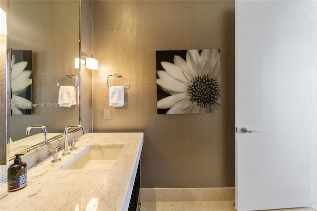 bathroom featuring baseboards and vanity