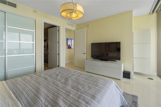 bedroom with visible vents and light tile patterned floors