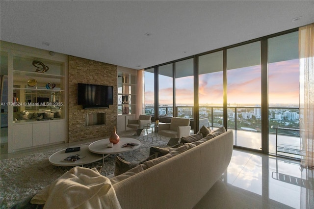 living area featuring tile patterned floors, floor to ceiling windows, built in features, and a fireplace