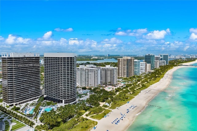 drone / aerial view featuring a view of city, a view of the beach, and a water view