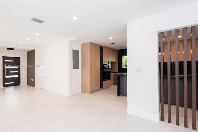 spare room featuring recessed lighting, visible vents, marble finish floor, and electric panel