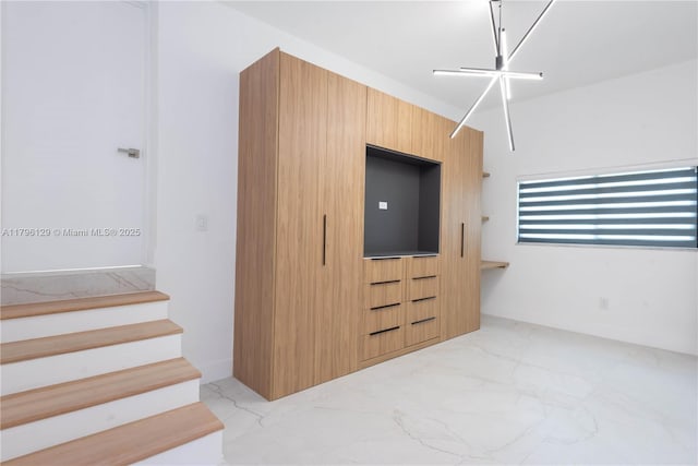 interior space with built in features and marble finish floor