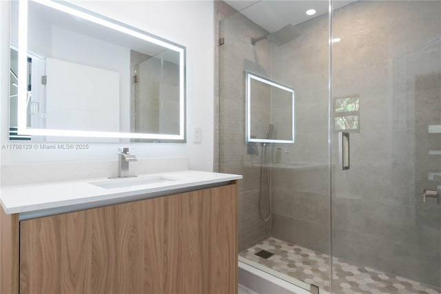 full bath with vanity and a stall shower