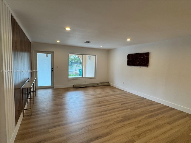 unfurnished room featuring light wood-style floors, recessed lighting, baseboards, and visible vents