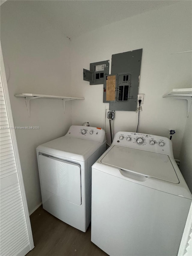 laundry room with independent washer and dryer, dark wood-style flooring, laundry area, and electric panel