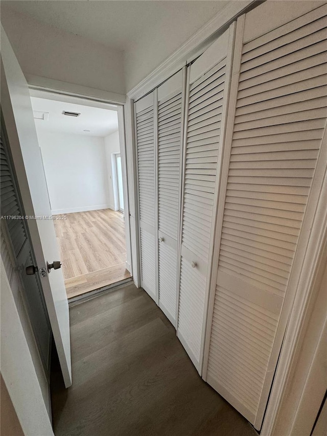 corridor with dark wood-type flooring