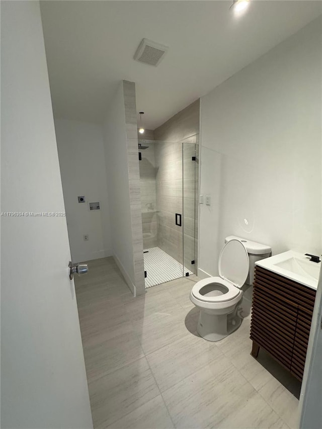 bathroom with visible vents, a stall shower, toilet, and vanity