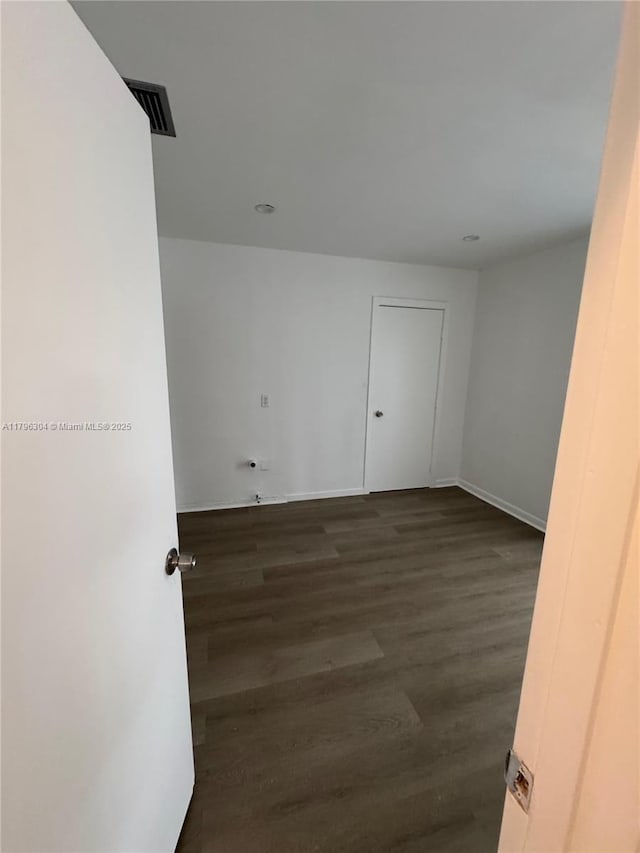 unfurnished room featuring wood finished floors and visible vents