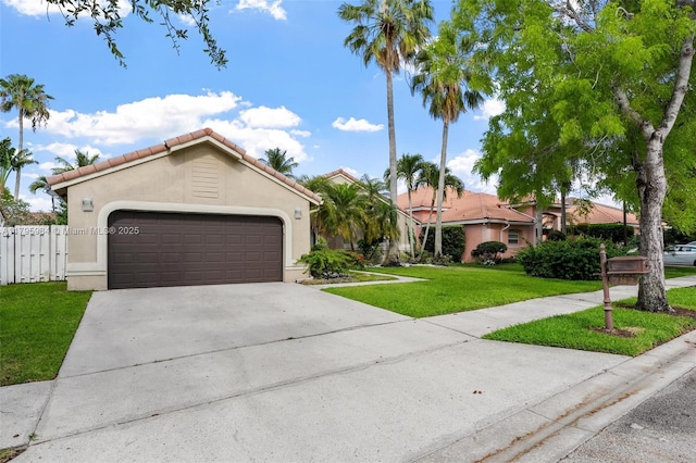 mediterranean / spanish house featuring an attached garage, a tiled roof, stucco siding, a front lawn, and driveway