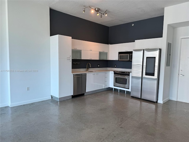 133 NE 2nd Ave Unit 1905, Miami, FL 33132 - kitchen with appliances with stainless steel finishes, a high ceiling, white cabinets, light countertops, and finished concrete floors