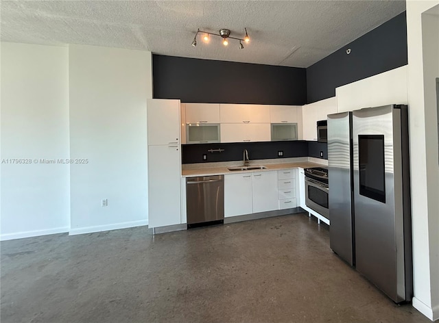 133 NE 2nd Ave Unit 1905, Miami, FL 33132 - kitchen with appliances with stainless steel finishes, light countertops, white cabinets, concrete floors, and track lighting
