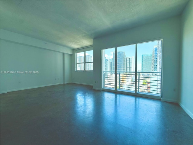 133 NE 2nd Ave Unit 1905, Miami, FL 33132 - spare room with finished concrete flooring, a textured ceiling, and a view of city